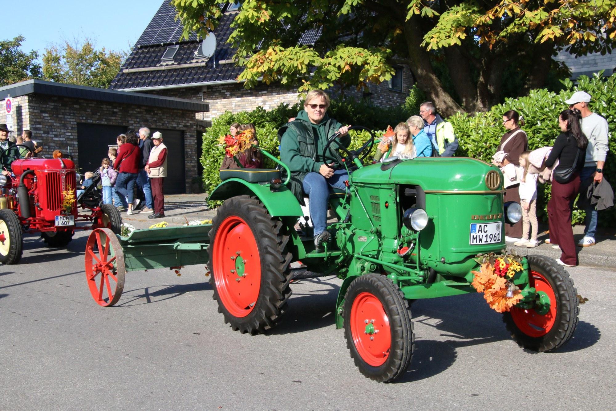 Grüner Oldtimertraktor vor Publikum beim Erntedankzug Walheim 2026.
